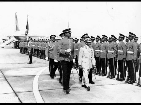 His Imperial Majesty, Emperor Haile Selassie I, inspecting a guard of honour of the 1st Battalion, Jamaica Regiment, at the Montego Bay Airport shortly before departure from Jamaica on Sunday, April 24, 1966. Escorting him is Major Leslie Lloyd, commander 