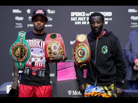 Credit: AP Errol Spence Jr (left) and Terence Crawford pose during a news conference on Thursday in Las Vegas. The two are scheduled to fight in an undisputed welterweight championship boxing match tonight in Las Vegas.