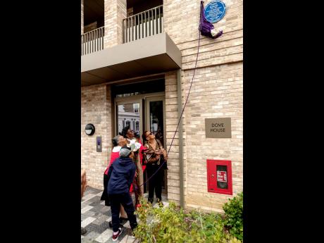 Monica Roberts (right) is thrilled to be  joined by family for the unveiling of the Blue Plaque honouring the late Sonny Roberts, as photographer Lewis Patrick captures the historic moment.