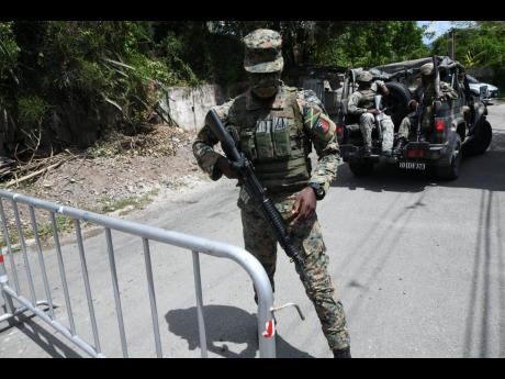 Members of the Jamaica Defence Force at a checkpoint in August Town, St Andrew, in June 2021.