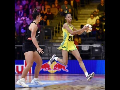 Sunshine Girls goal keeper Shamera Sterling (right) grabs the ball ahead of her New Zealand opponent during a Pool G second-round Netball World Cup game at the Cape Town International Convention Centre in South Africa yesterday.