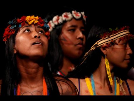 Tembe Indigenous youths perform a ritual dance at the start of a ceremony presenting Brazil’s national Indigenous census at Theater da Paz for a in Belem, Brazil.