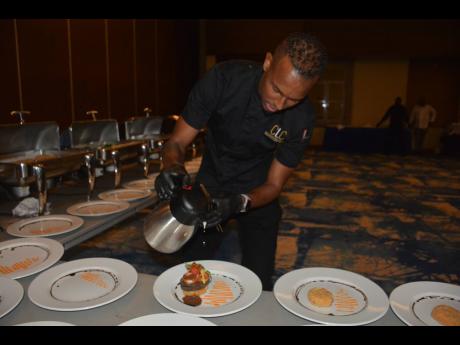 Credit: Janet Silvera Executive chef Brian Lumley putting the final touch on his entree.