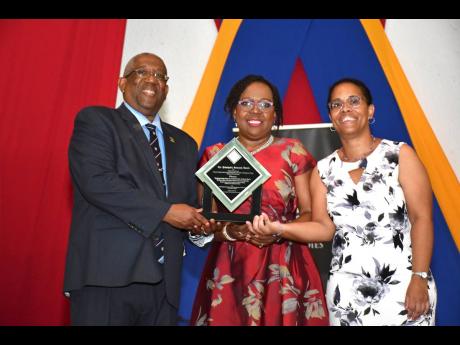 Credit: Contributed From left: Professor Dale Webber presenting the Special Award for ‘COVID-19 Impact and Faculty of Social Sciences Research Project with the Greatest Business/Economic/Development Impact 2023’ to Professor Aldrie Henry-Lee, pro- vice-chancellor, graduat