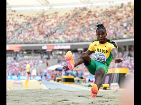 Credit: Gladstone Taylor Wayne Pinnock on his way to cutting the sand at 8.54 metres in the preliminary round of the long jump at tghe World Athletics Championships inside the National Athletics Centre on Wednesday.