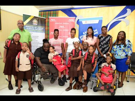 Pearnel Charles Jr (third right, front row), minister of labour and social security; Jeneard Williamson (third left, front row), Digicel education and special-needs project officer; and Antonica Gunter-Gayle (right, back row), Early Stimulation Programme d