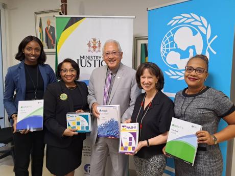 Credit: Contributed Minister of Justice Delroy Chuck (centre) and UNICEF Country Representative Olga Isaza (second right) who handed over assessment tools that will assist in identifying the areas of support that children in the Child Diversion Programme needs. Also displayin