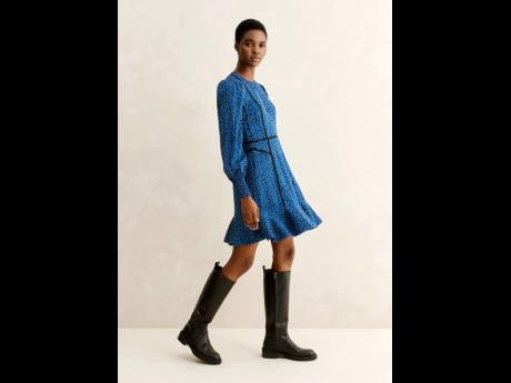 Discovered on social media by SAINT CEO Deiwght Peters back in 2019, Aworo is chic in ME + EM’s mille fleur print short fit and flare dress and refined riding boots.