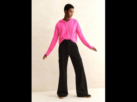 Easy does it is Aworo Mayowa in a relaxed cashmere hoodie and flared cargo trousers.