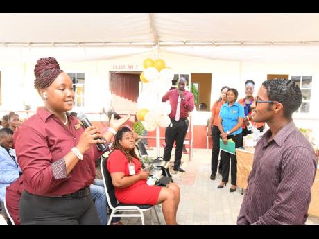 Credit: Contributed Kenneisha Gordon (foreground), student in the Business Administration in the Accounting/Finance and Management programme at the Portmore Community College (PCC), poses a question to Ricardo Dystant, chief of digital transformation and special projects, JN