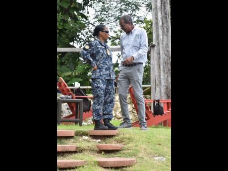 Rear Admiral Antonette Wemyss Gorman, chief of defence staff of the Jamaica Defence Force, engages Dr Gavin Bellamy, executive director of the National Fisheries Authority, in conversation during a ceremony to scuttle the ‘Paul Bogle’ in Portland on Su