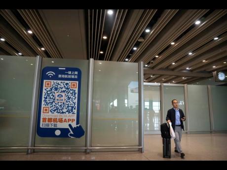 A traveller walks through the international flight arrivals area at Beijing Capital International Airport in Beijing, on April 26, 2023.