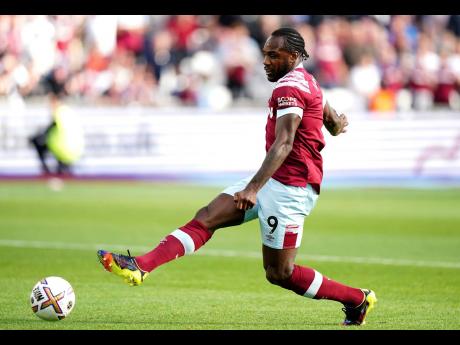 West Ham United’s Michail Antonio scores their side’s third goal of the game during the English Premier League football match against Fulham at the London Stadium in London, Sunday October 9, 2022. 