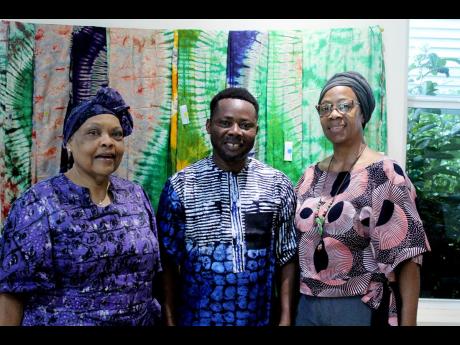 Valerie Veira, executive director at the Jamaica Business Development Corporation; Nigerian cultural diplomat, visual artist Alao Luqman; and Mariam Hinds Smith, dean of the School of Visual Arts, Edna Manley College, blending into the background of fabric