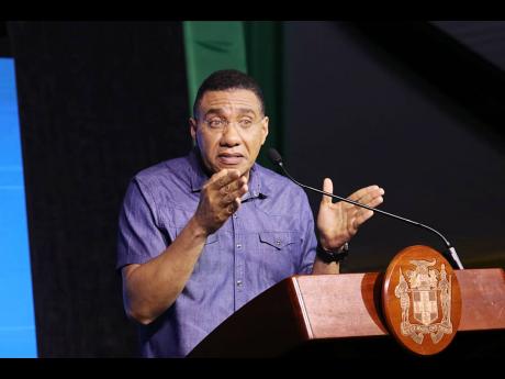 Prime Minister Andrew Holness addressing the town hall meeting at Harmony Beach Park in Montego Bay, St James on Thursday.