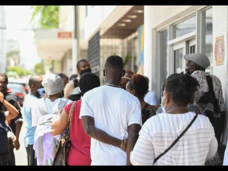 
In this 2021 photo, people are seen waiting outside the police criminal records office.