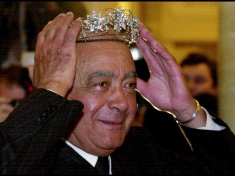 
Mohamed Al Fayed, then owner of Harrods department store, in London, tries on a tiara at the start of the January sales on January 3, 2001.