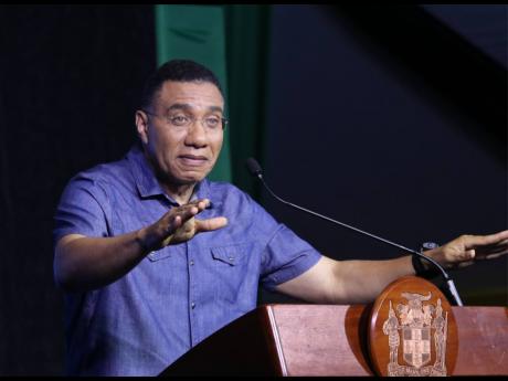 Credit: Ashley Anguin Prime Minister Andrew Holness addresses the audience during a town hall meeting on housing and land at the Harmony Beach Park in Montego Bay, St James, last Thursday.