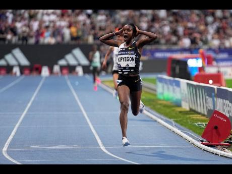 Faith Kipyegon, of Kenya, crosses the finish line to win the women’s 5000m in a new world record,  14:05.20, at the Paris Diamond League athletics meet on Friday, June 9, 2023. 