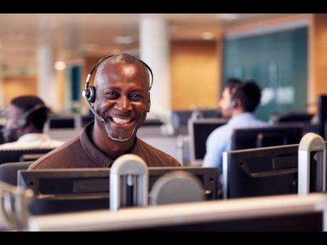 An image of a customer service executive interacting with a customer over the phone.