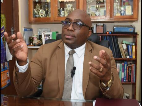 Leighton Johnson, president of the Jamaica Teachers’ Association, speaking with the media yesterday on teacher resignations, school security, and infrastructure concerns.