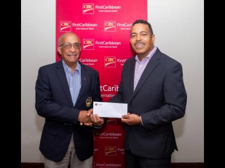 CIBC FirstCaribbean continued its support for national sports with a donation towards the purchase of a school bus to transport students to and from track, football and other sporting events. Here, Victor Tomlinson (left), president of the Munro College Ol
