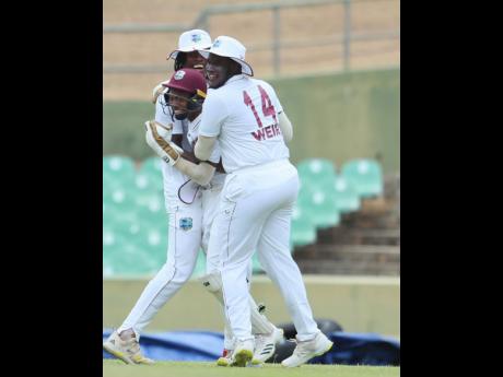Credit: CWI Photo West Indies Under-19 opener, Adrian Weir (right), congratulates wicketkeeper, Jewel Andrew (centre), for taking a catch against Sri Lanka Under-19s in the first youth ‘Test’ at the Rangiri Dambulla International Stadium yesterday.