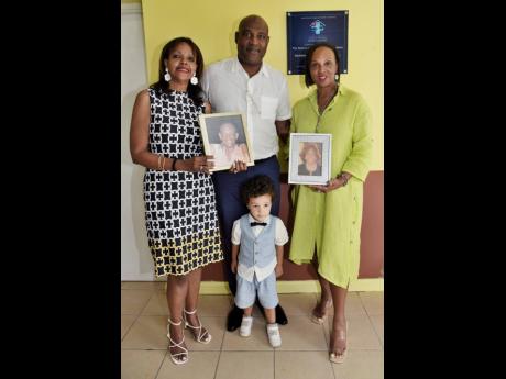 Credit: Ian Allen Daughter Kim Richards (left), son Richard Watson (second left), grandson Edgar Watson (second right), and daughter Dr Jacqueline Watson (right), director of the Watson Family RalRosa Foundation, pose with pictures of Keith and Phyllis Watson, during an of