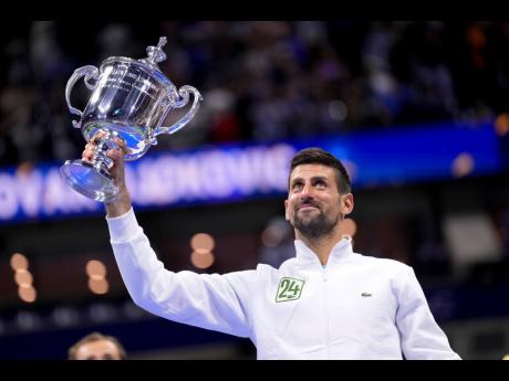 Credit: AP Novak Djokovic of Serbia holds up the championship trophy after defeating Daniil Medvedev of Russia in the men’s singles final of the U.S. Open Tennis Championships in New York yesterday.