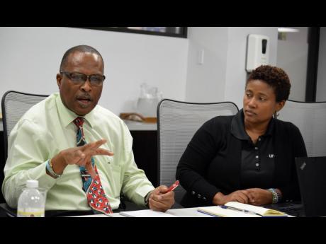 Credit: Kenyon Hemans/Photographer Novia Condell, health specialist at UNICEF Jamaica, listens as Dr Kevin Goulbourne, director, mental health and substance use in the Ministry of Health & Wellness, makes a point during an interview on Monday.