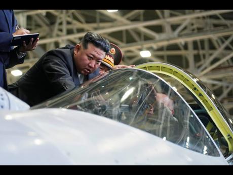 North Korean leader Kim Jong Un looks at a military jet cockpit while visiting a Russian aircraft plant that builds fighter jets in Komsomolsk-on-Amur, about 6,200 kilometres east of Moscow, Russia, yesterday.