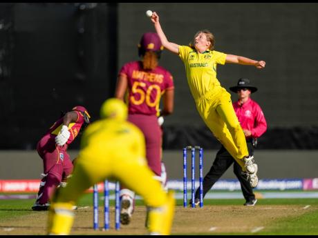 Credit: AP Photo Darcie Brown of Australia (second right) attempts to field off her own bowling to the West Indies’ Hayley Matthews during the first semifinal match of the Women’s Cricket World Cup in Wellington, New Zealand on Wednesday, March 30, 2022.