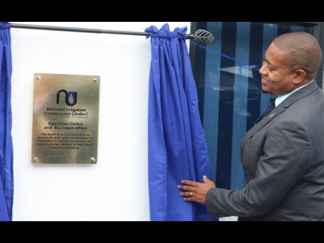 Minister of Agriculture, Fisheries and Mining Floyd Green unveils the plaque at the  commissioning ceremony for the National Irrigation Commission’s Operation Centre and Rio Cobre office, at 15 Barnett Street, St Catherine.
