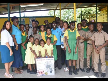 Members of the Lay Magistrate Association of Jamaica, St. James Chapter  with students and teachers of the Farm Primary and Infant School  during a presentation of six fans to the school on Wednesday, September 13.