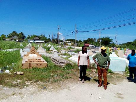 Desmond McKenzie (centre), minister of local government and community development, and Hanover Western Member of Parliament Tamika Davis (left) examine the state of the Lucea cemetery in Hanover during a tour on Thursday.