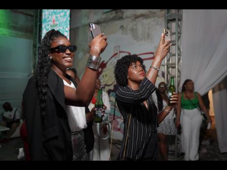 Asheka Robinson (left) and Chanelle DaCosta capture the moment.