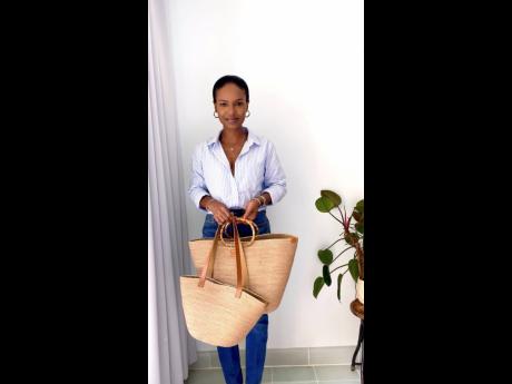 Credit: Contributed CEO of Kalia & Co Designs, Taneish Miller, poses with some of her own creations.