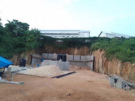 The retaining wall being built by the Doer of Faith Church of God without any drawings being submitted to the Hanover Municipal Corporation, in Orchard Gardens, Hopewell, adjacent to  Hopewell High School.