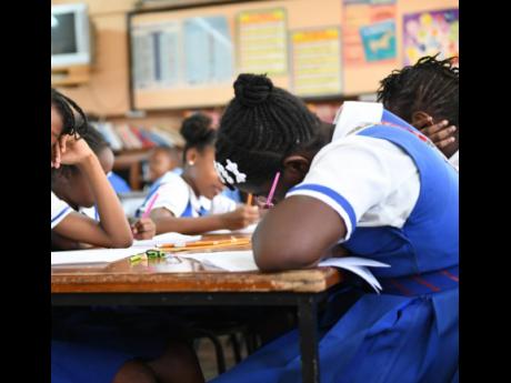 In this file photo students are seen writing exams. 