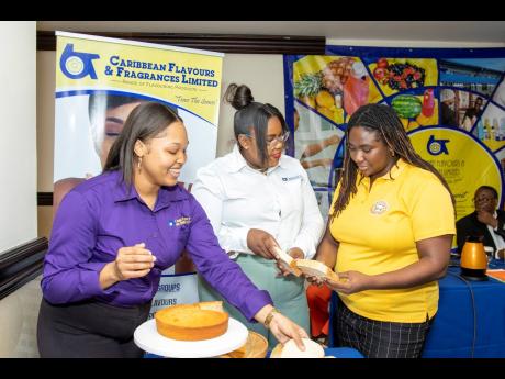 From left: Allison Phipps, business development officer, and Joddian Howard, senior product development officer, from CFF, explain the differences between pre-established baked goods, one with the new ingredient and one without, to seminar attendee, Janiez