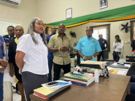 Colette Roberts Risden (left), permanent secretary in the Ministry of Labour and Social Security (MLSS), addresses the St Elizabeth Parish Office team members while Pearnel Charles Jr (centre), minister of labour and social security, and Dr Norman Dunn (ri