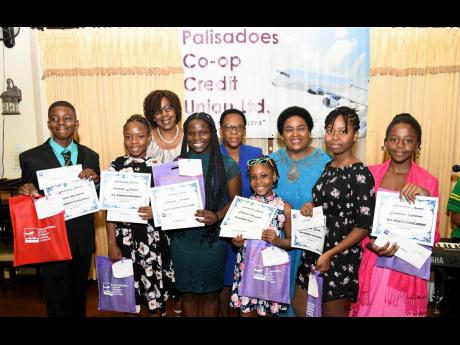 Dr Maxine Wilson (back row, third left), general manager, Palisadoes Co-operative Credit Union; Celay Harwood-Gayle (back, centre), president, board of directors and guest speaker; Donna Parchment Brown (third right), political ombudsman, with the scholars