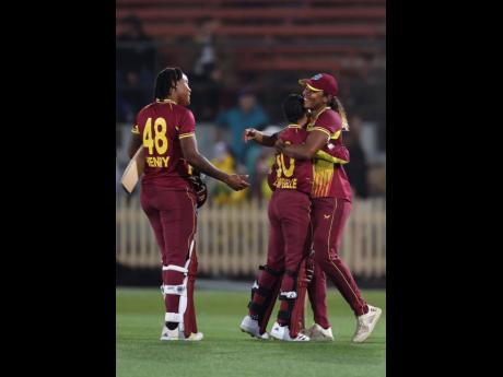 From left: West Indies Women’s Chinelle Henry, Shemaine Campbelle, and their captain Hayley Matthews congratulate each other after a world record women’s T20I run chase against Australia at the North Sydney Oval on Monday.