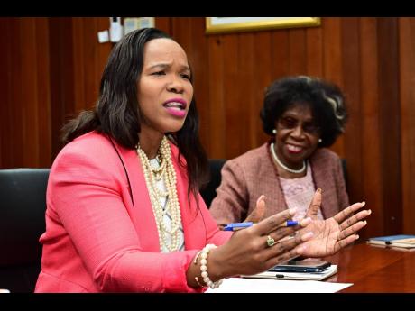 Ministry of Education and Youth Permanent Secretary Dr Kasan Troupe (left) speaking at the launch of the Inter-American Development Bank’s Digital Skills Project at the Ministry of Education and Youth on Wednesday. Looking on is Dr Winsome Gordon, chief 