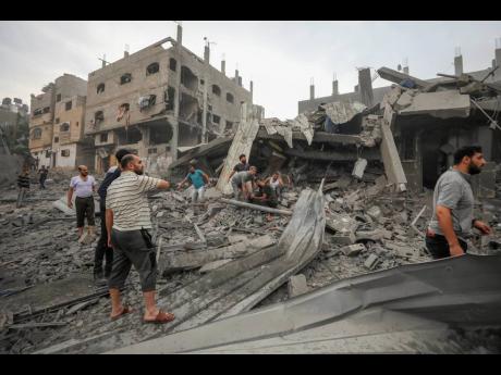 Palestinians search for survivors of Israeli aerial bombing on Jabaliya, near Gaza City on Wednesday.