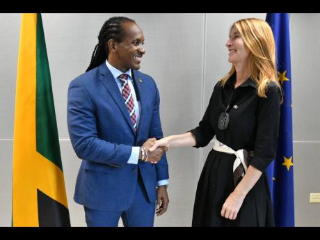 Minister of State in the Ministry of Foreign Affairs and Foreign Trade, Alando Terrelonge, exchanges greetings with Deputy Secretary General for the European Union External Action Service, Helena Koning, at the seventh  Jamaica/European Union Political Dia