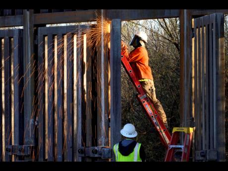 
Crews construct a section of border wall in San Bernardino National Wildlife Refuge, in December 2020 in Douglas, Arizona. 