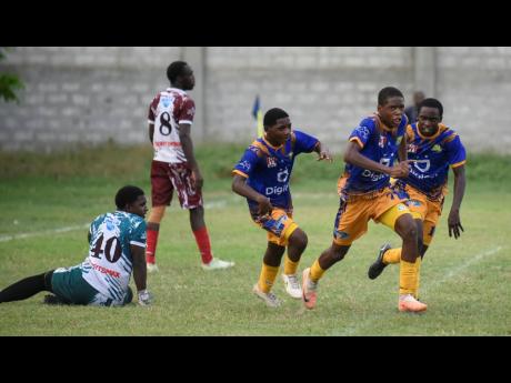 
Jonathan Grant High School players celebrate scoring against Eltham High School during a Manning Cup game at Jonathan Grant yesterday. The game ended in a 2-2 draw.