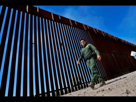  Border Patrol Deputy Chief for the Tucson Sector, Justin De La Torre, walks along the US-Mexico border fence.