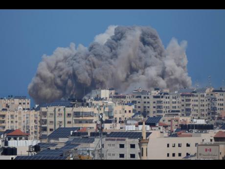 Smoke rises following an Israeli airstrike in Gaza City on October 12.